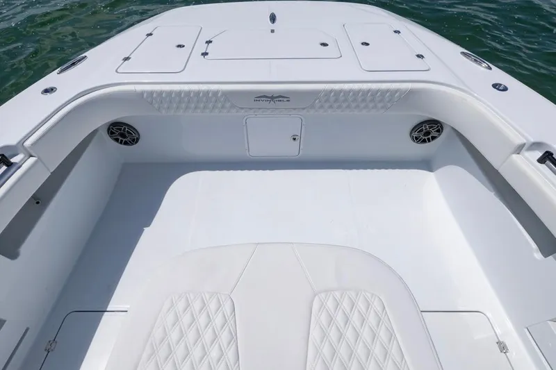 Slide: The Image of 2026 Invincible 36 Catamaran interior with white seating and storage compartments. - 13