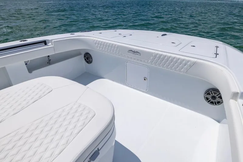 Slide: The Image of 2026 Invincible 36 Catamaran interior with white seating and ocean backdrop. - 14