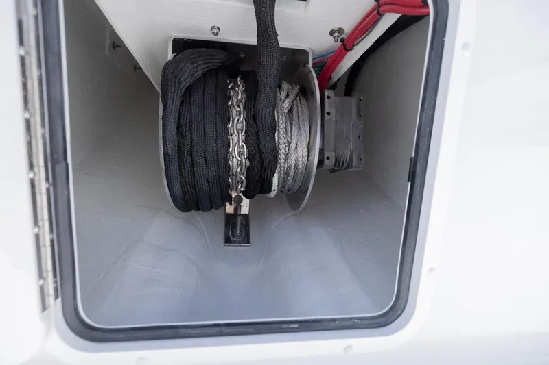 Slide: The Image of Anchor storage compartment on 2026 Invincible 36 Catamaran, featuring ropes and chains. - 19
