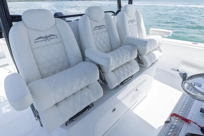 Slide: The Image of Luxurious seating on 2026 Invincible 36 Catamaran, featuring plush white upholstery and armrests. - 30