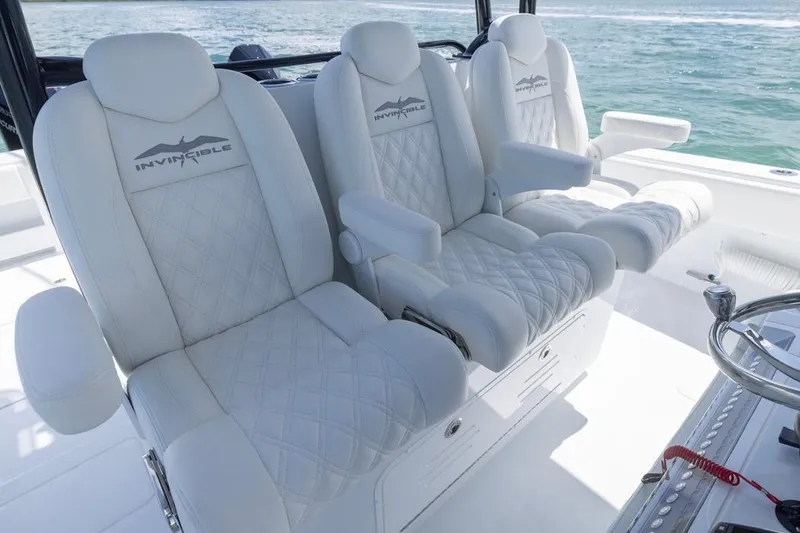 Slide: The Image of Luxurious seating on 2026 Invincible 36 Catamaran, featuring elegant white upholstery and ocean backdrop. - 31