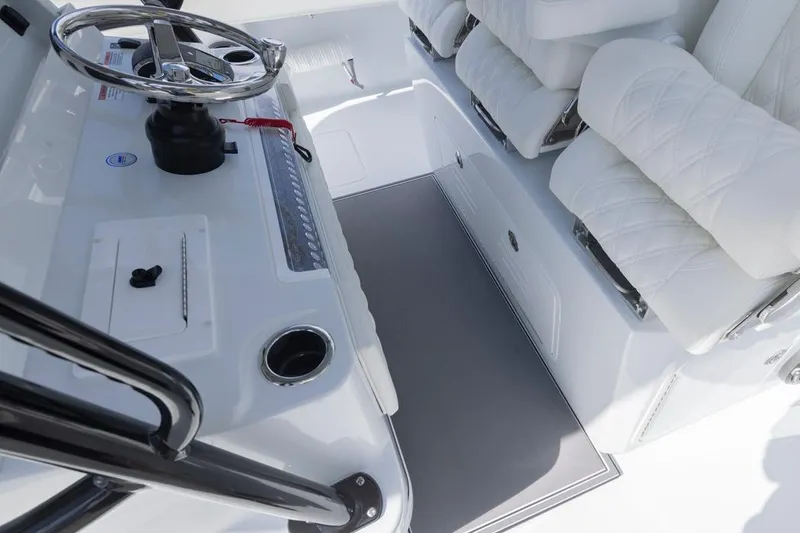 Slide: The Image of Interior of 2026 Invincible 36 Catamaran with steering wheel and cushioned seating. - 32