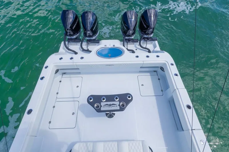 Slide: The Image of 2026 Invincible 36 Catamaran with four powerful engines on turquoise water. - 34