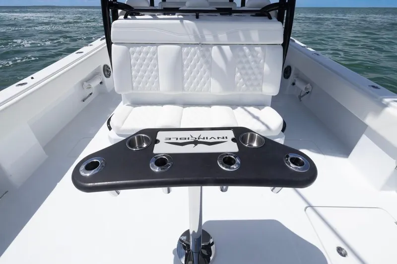 Slide: The Image of 2026 Invincible 36 Catamaran interior with seating and cup holders on open water. - 37
