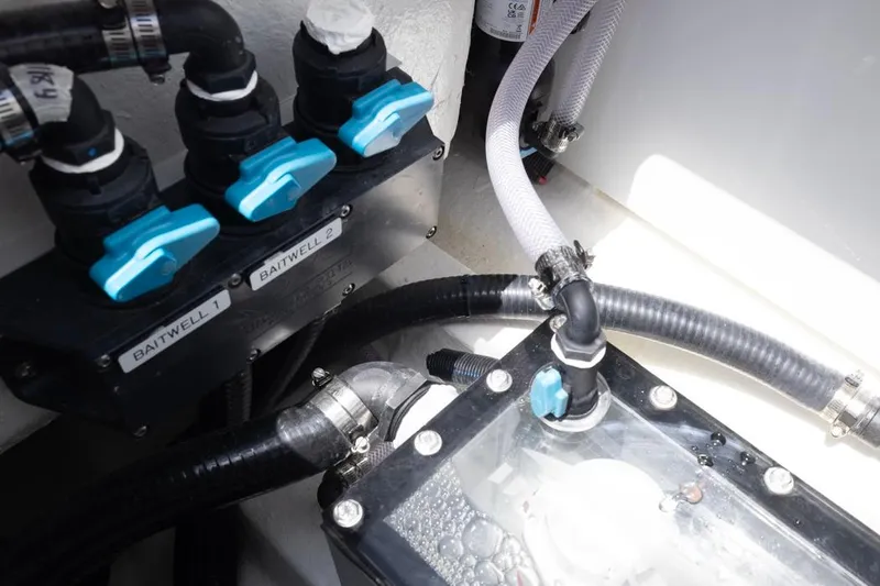 Slide: The Image of Baitwell system in 2026 Invincible 36 Catamaran, featuring labeled valves and hoses. - 47