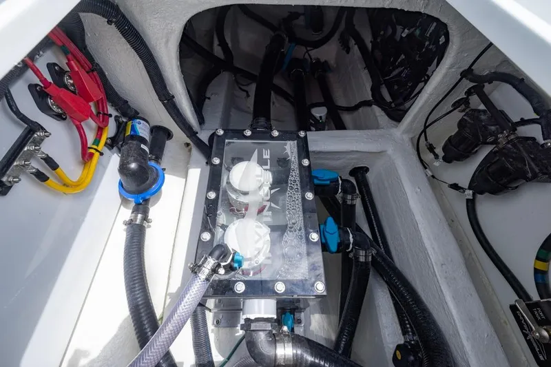 Slide: The Image of Engine compartment of 2026 Invincible 36 Catamaran with visible wiring and components. - 49