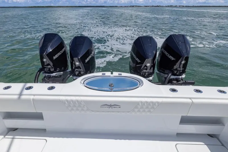 Slide: The Image of 2026 Invincible 36 Catamaran with four Mercury engines on open water. - 50