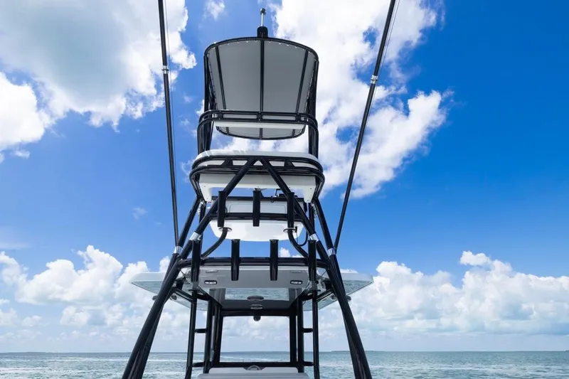 Slide: The Image of Invincible 36 Catamaran 2026, tower view against blue sky and ocean backdrop. - 7