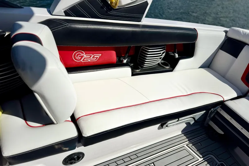 Slide: The Image of 2015 Nautique Super Air Nautique G25 Coastal Edition interior seating with red accents. - 15