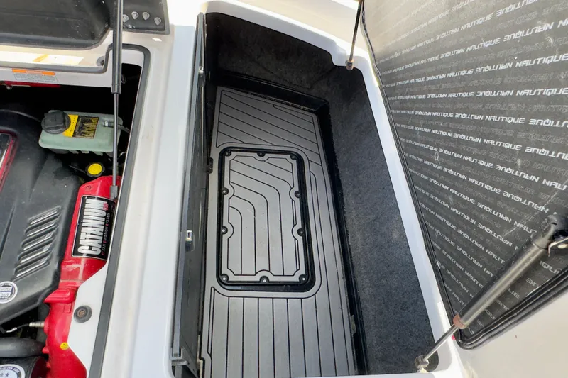 Slide: The Image of 2015 Nautique Super Air Nautique G25 Coastal Edition engine compartment and storage area. - 19