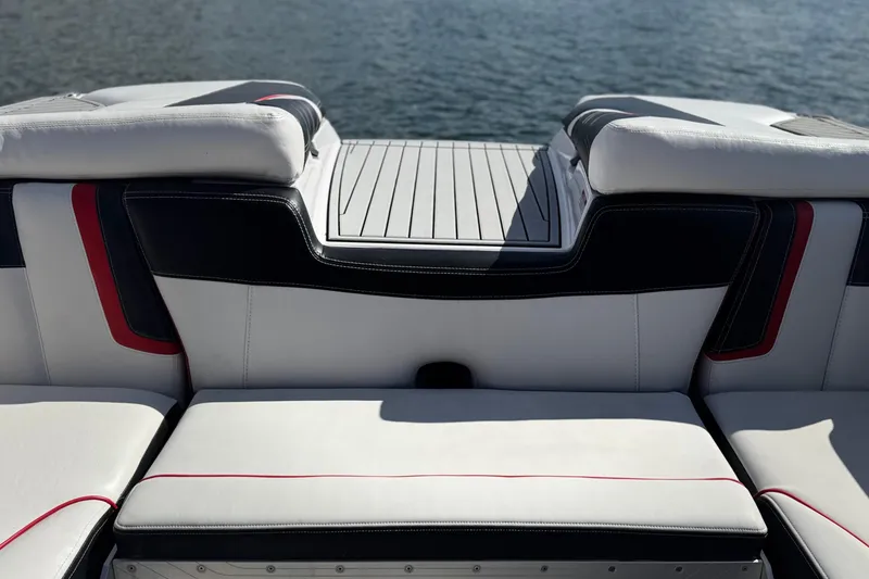 Slide: The Image of 2015 Nautique Super Air Nautique G25 Coastal Edition boat interior with white and black seating. - 22