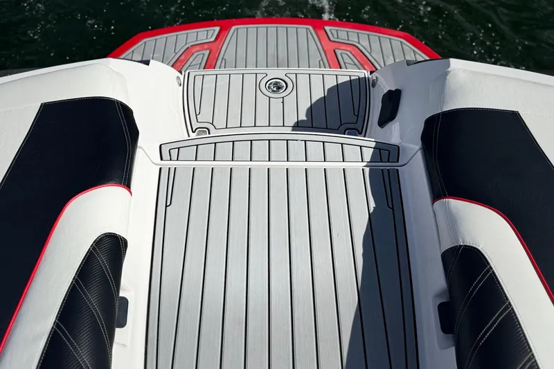 Slide: The Image of 2015 Nautique Super Air Nautique G25 Coastal Edition boat deck with sleek design and red accents. - 23