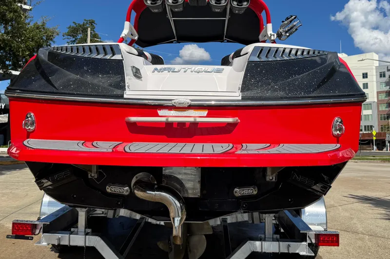 Slide: The Image of 2015 Nautique Super Air Nautique G25 Coastal Edition, red and black, rear view on trailer. - 24