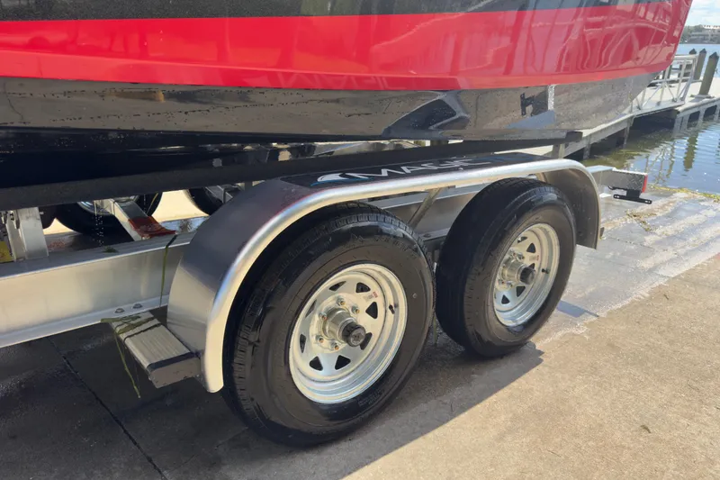 Slide: The Image of Trailer of 2015 Nautique Super Air Nautique G25 Coastal Edition near water. - 26