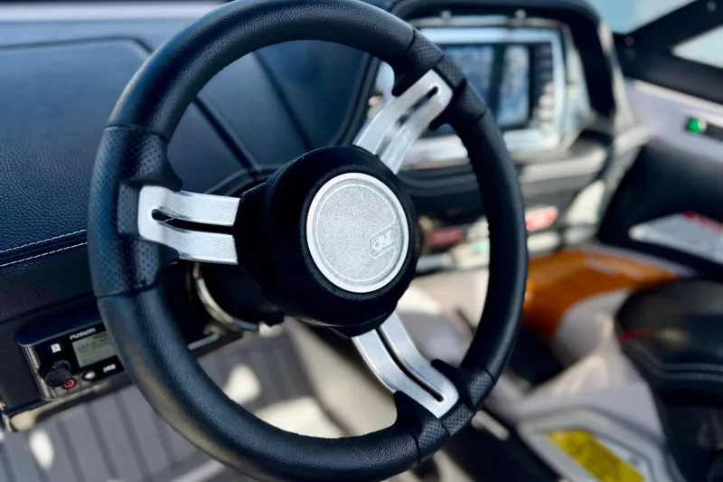 Slide: The Image of Steering wheel of 2015 Nautique Super Air Nautique G25 Coastal Edition boat. - 3