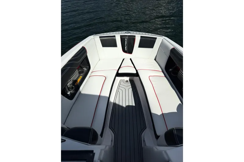 Slide: The Image of 2015 Nautique Super Air Nautique G25 Coastal Edition boat interior with white seating and red accents. - 7