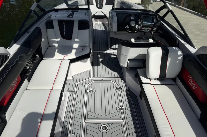 Slide: The Image of 2015 Nautique Super Air Nautique G25 Coastal Edition interior with sleek seating and modern dashboard. - 8