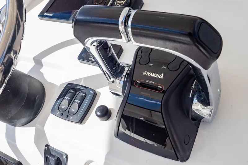 Slide: The Image of Close-up of Yamaha throttle controls on a 2015 Intrepid 327 Cuddy boat. - 14