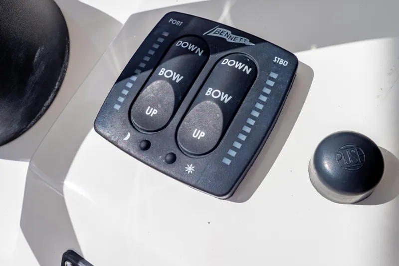 Slide: The Image of Bennett trim tab control panel on 2015 Intrepid 327 Cuddy boat dashboard. - 21