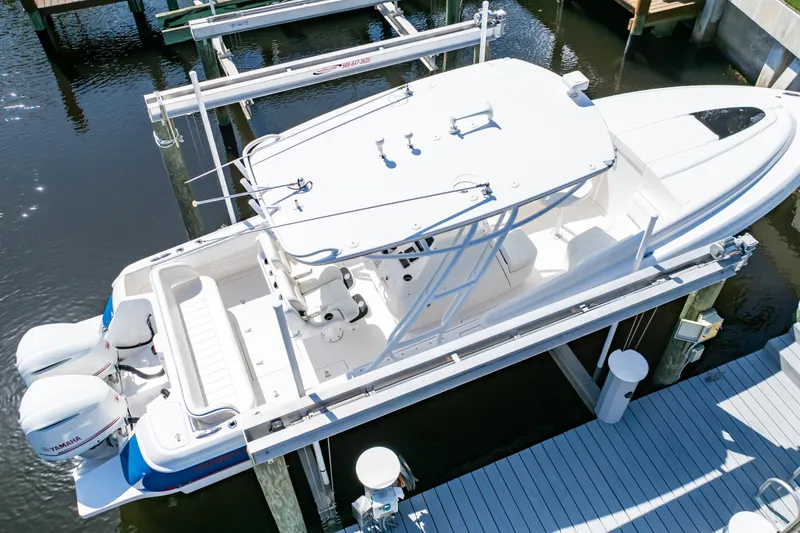 Slide: The Image of 2015 Intrepid 327 Cuddy boat docked with twin Yamaha engines, aerial view. - 22