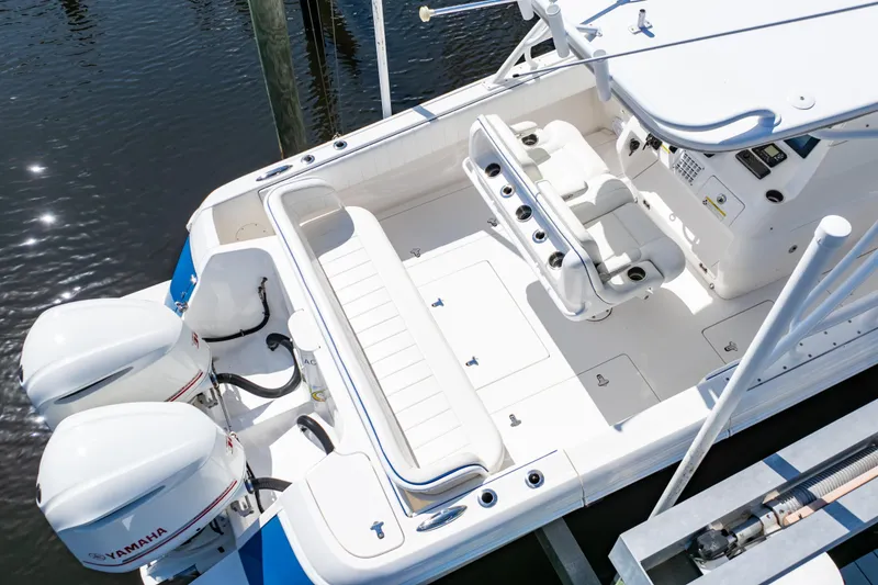 Slide: The Image of 2015 Intrepid 327 Cuddy boat with Yamaha engines, featuring spacious seating and modern controls. - 23