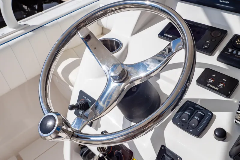 Slide: The Image of Steering wheel and controls of a 2015 Intrepid 327 Cuddy boat. - 24