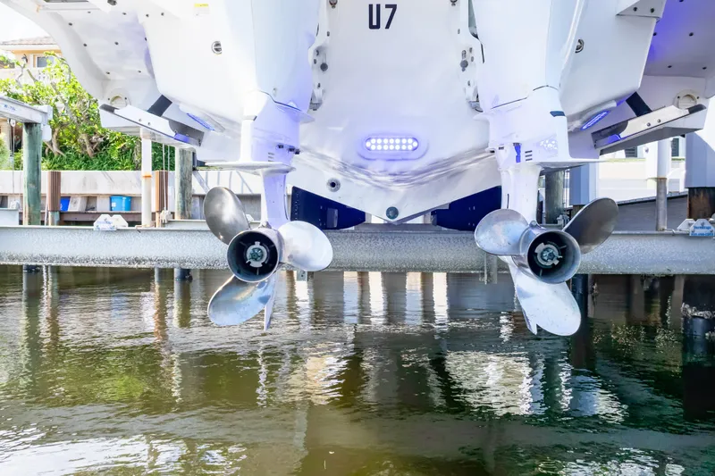 Slide: The Image of 2015 Intrepid 327 Cuddy boat propellers above water on a lift. - 33
