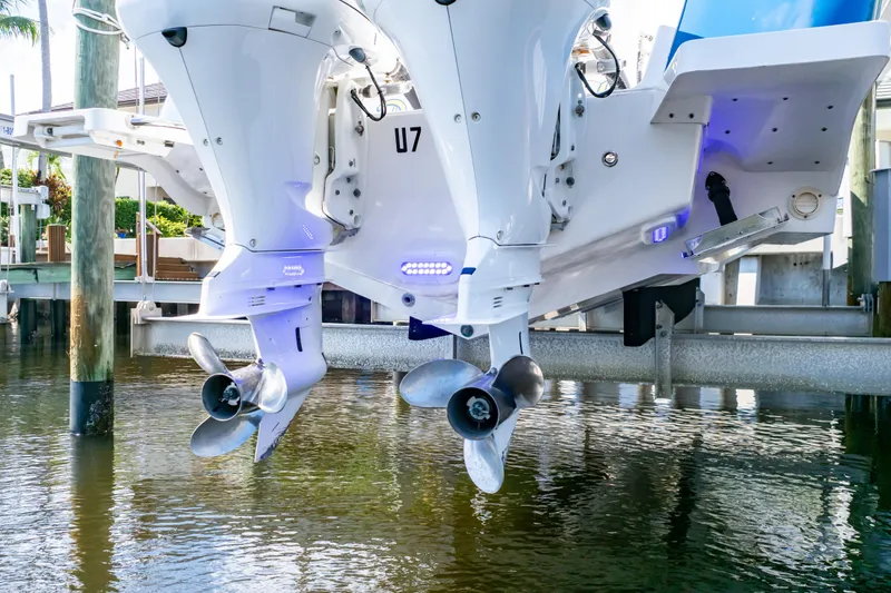 Slide: The Image of 2015 Intrepid 327 Cuddy boat engines above water at dock. - 36