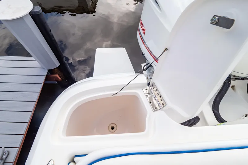 Slide: The Image of Open storage compartment on a 2015 Intrepid 327 Cuddy boat near a dock. - 40