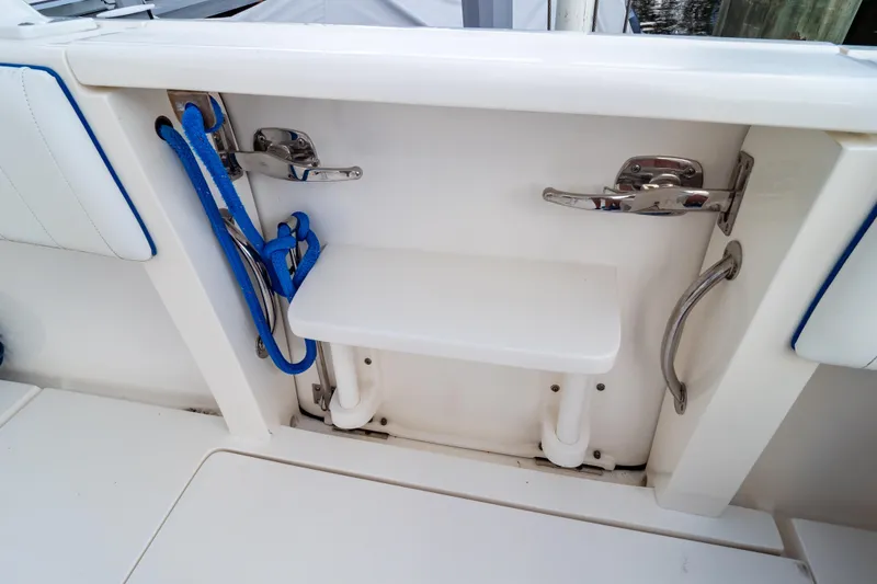 Slide: The Image of 2015 Intrepid 327 Cuddy boat interior with blue rope and stainless steel fittings. - 47