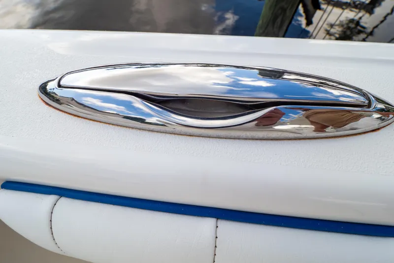 Slide: The Image of Chrome cleat on 2015 Intrepid 327 Cuddy boat, reflecting sky and surroundings. - 49