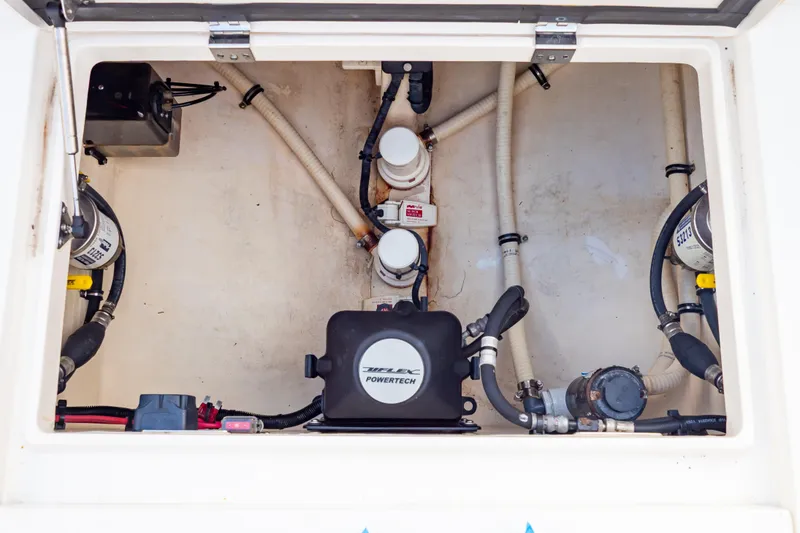 Slide: The Image of Engine compartment of a 2015 Intrepid 327 Cuddy boat, showcasing mechanical components. - 50