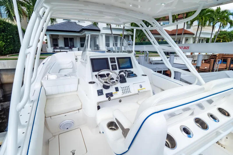 Slide: The Image of 2015 Intrepid 327 Cuddy boat interior with modern dashboard and seating. - 54