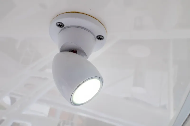 Slide: The Image of Close-up of a ceiling light fixture on a 2015 Intrepid 327 Cuddy boat. - 58