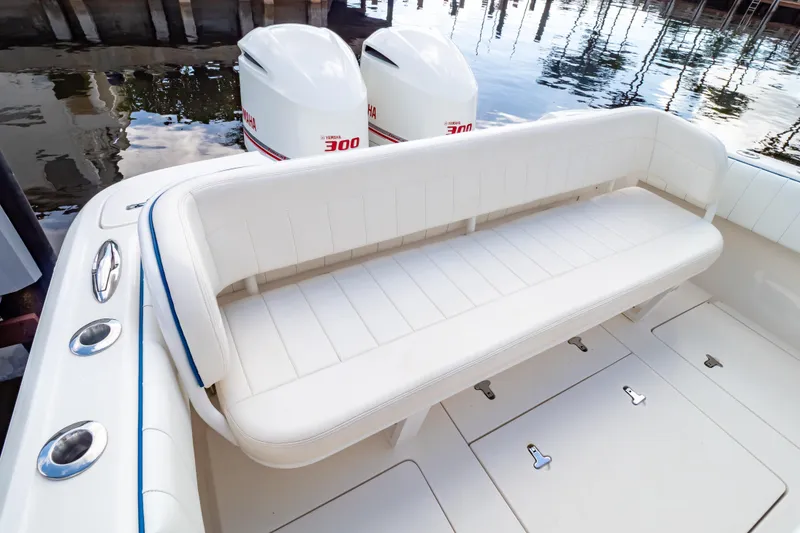 Slide: The Image of 2015 Intrepid 327 Cuddy boat with white seating and twin Yamaha 300 engines. - 6