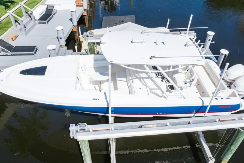 Slide: The Image of 2015 Intrepid 327 Cuddy boat docked on a lift, aerial view. - 63