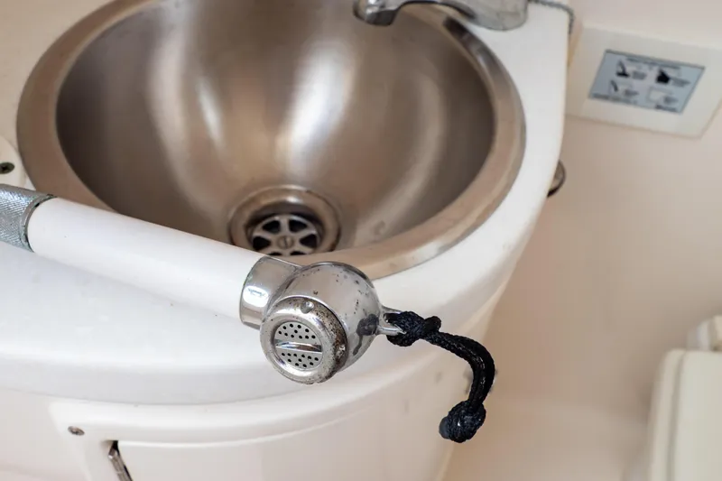 Slide: The Image of Stainless steel sink with a handheld showerhead on a 2015 Intrepid 327 Cuddy boat. - 75