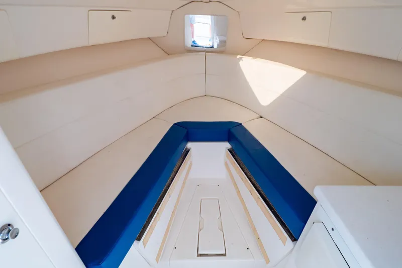 Slide: The Image of Interior of 2015 Intrepid 327 Cuddy boat with blue and white seating. - 76