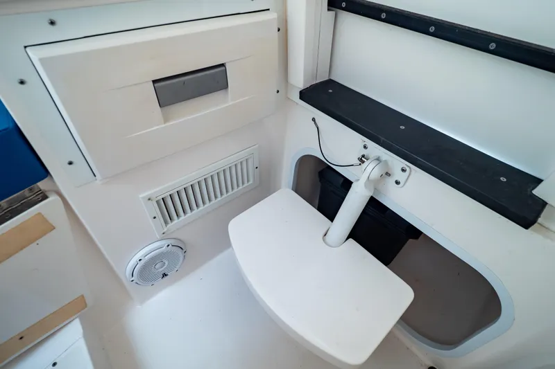 Slide: The Image of Interior view of a 2015 Intrepid 327 Cuddy boat, featuring seating and storage compartments. - 78