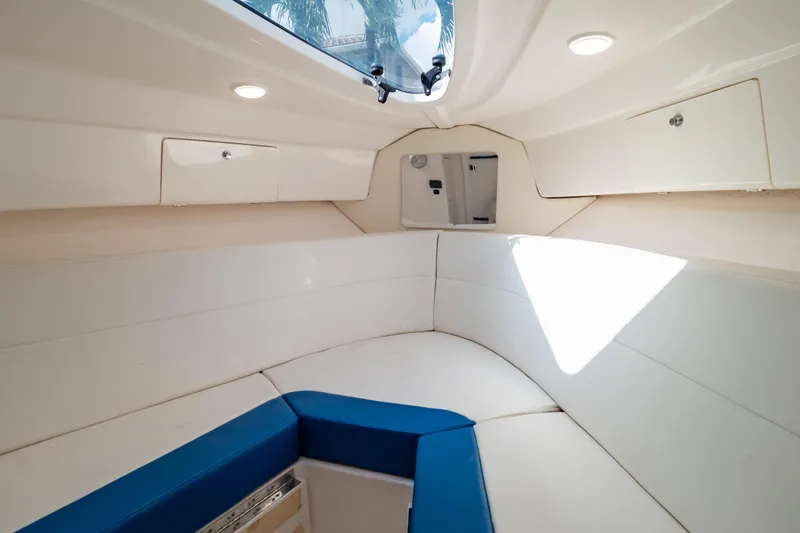 Slide: The Image of 2015 Intrepid 327 Cuddy interior with white seating and overhead hatch. - 79
