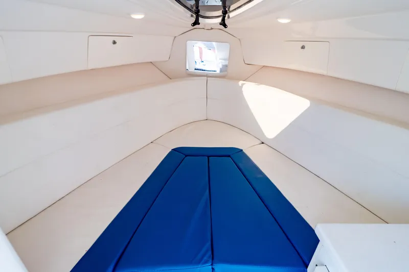 Slide: The Image of 2015 Intrepid 327 Cuddy interior with blue and white seating, modern design. - 8