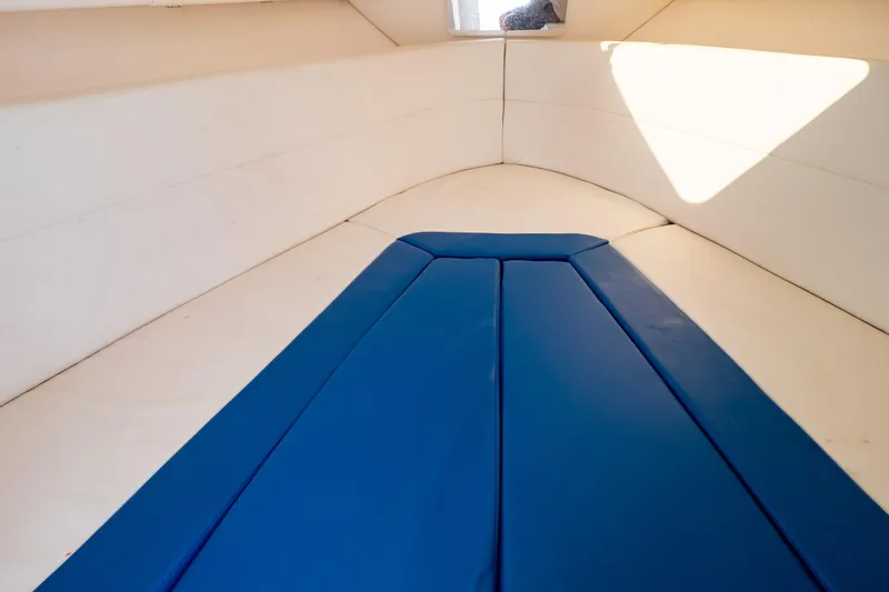 Slide: The Image of Interior of 2015 Intrepid 327 Cuddy boat with blue cushioned seating. - 83