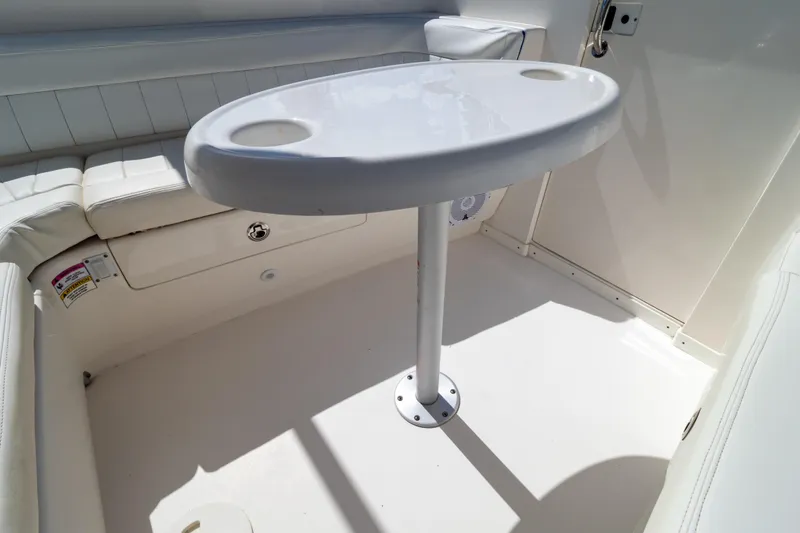Slide: The Image of 2015 Intrepid 327 Cuddy interior with white seating and oval table. - 86