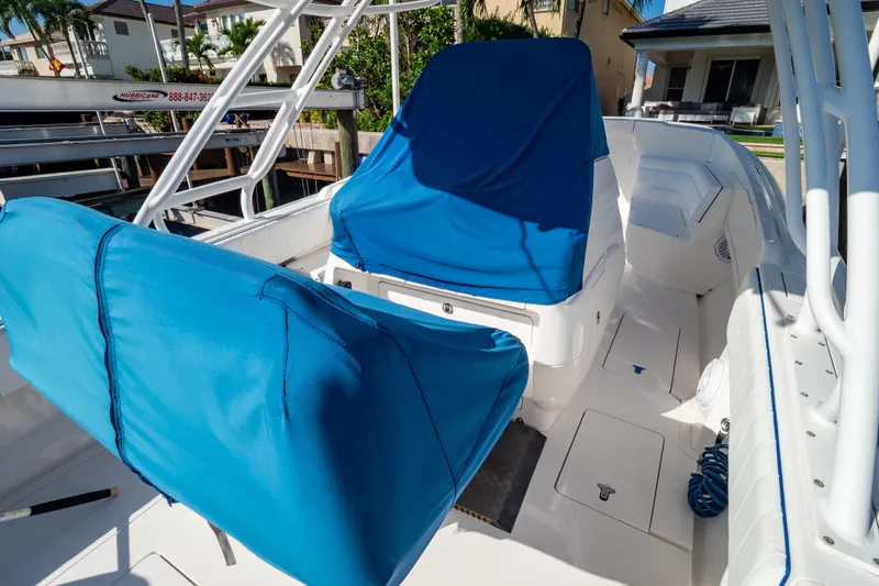 Slide: The Image of 2015 Intrepid 327 Cuddy boat interior with blue seat covers and white deck. - 88