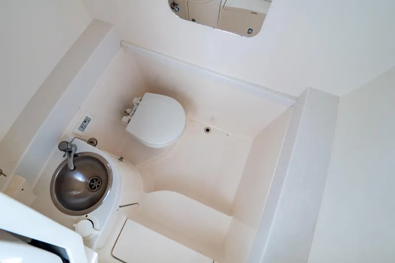 Slide: The Image of Compact bathroom in 2015 Intrepid 327 Cuddy boat with sink and toilet. - 9