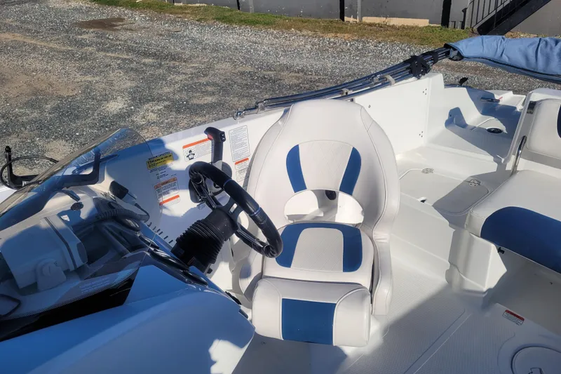 Slide: The Image of 2017 Tahoe 2150 boat interior with steering wheel and white-blue seating. - 11
