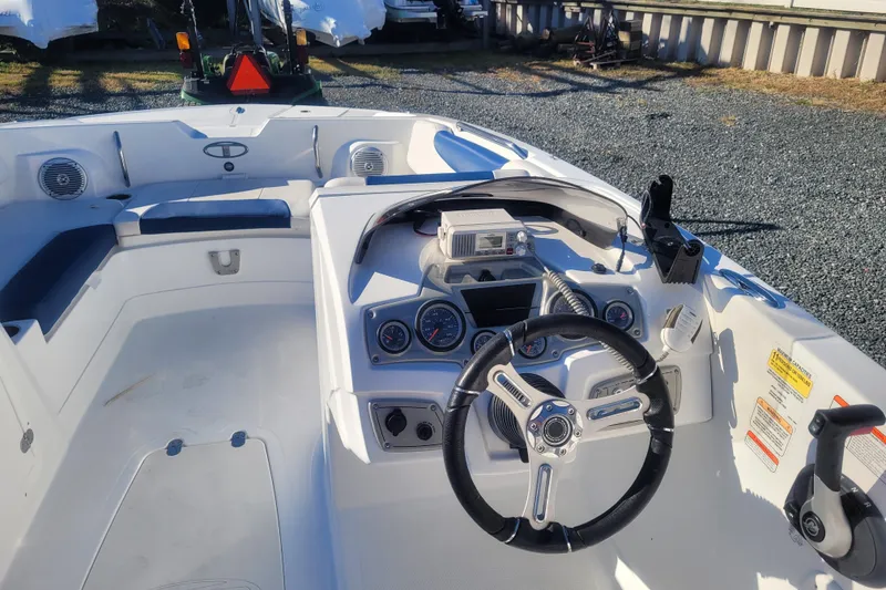 Slide: The Image of 2017 Tahoe 2150 boat interior with steering wheel and dashboard controls. - 12