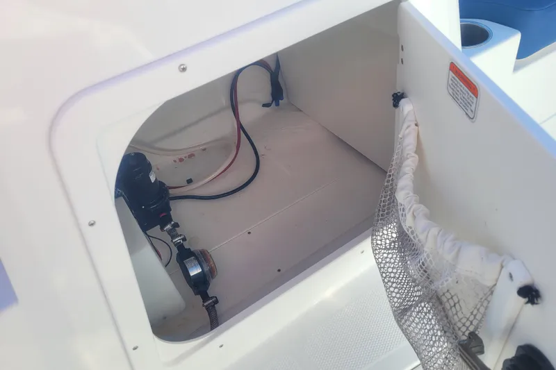 Slide: The Image of 2017 Tahoe 2150 boat storage compartment with wiring and mesh pocket. - 15