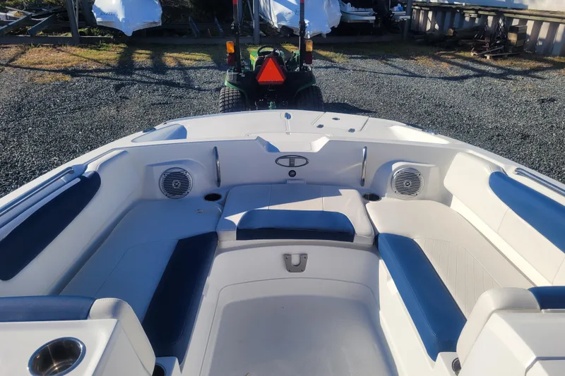 Slide: The Image of 2017 Tahoe 2150 boat interior with blue and white seating, outdoor setting. - 17