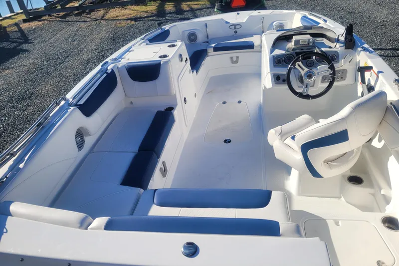 Slide: The Image of 2017 Tahoe 2150 boat interior with white and blue seating, steering wheel, and dashboard. - 8